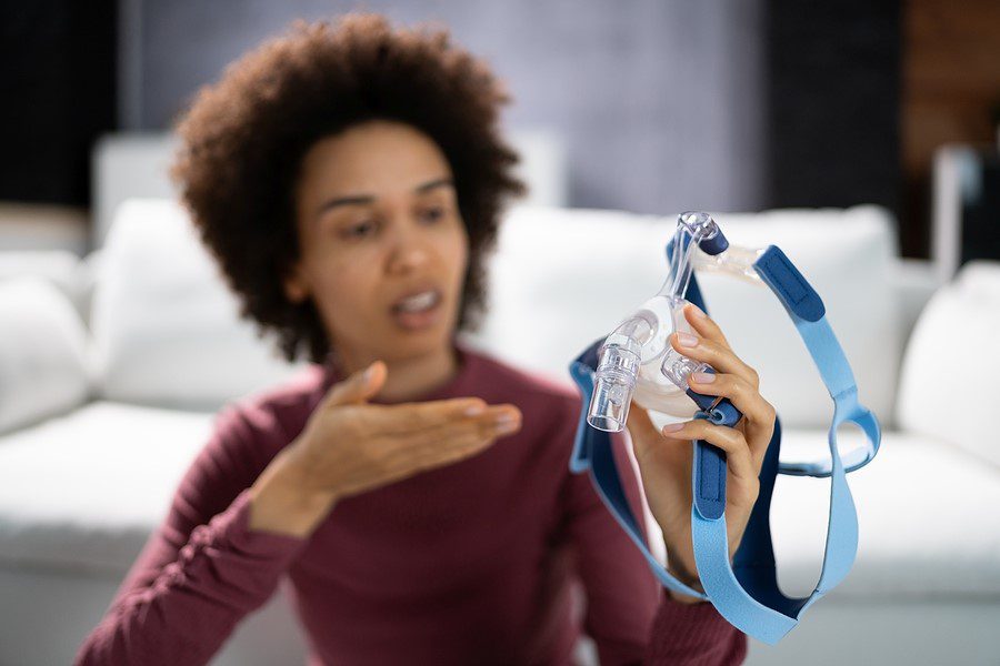 Woman holding a CPAP mask