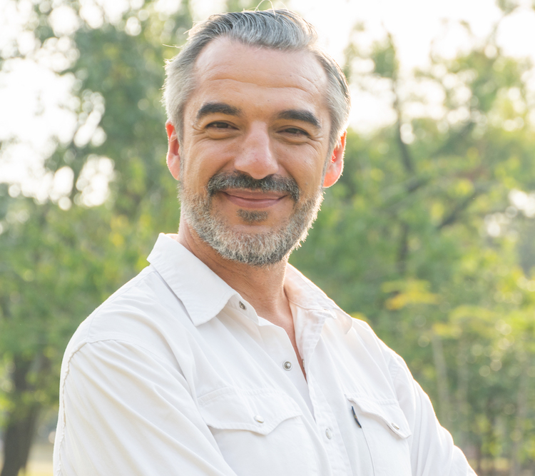 Portrait of senior man looking smile to camera at a park